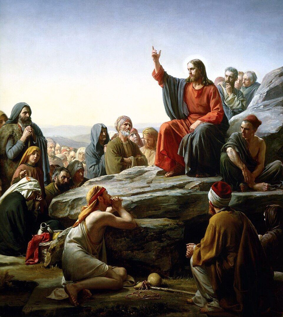 Carl Bloch, "The Sermon on the Mount" (19th century). Christ sits not on a throne but on a hillside, and around him is not a crowd but a multitude of distinct faces: a praying woman with a child, an old man, a beggar with a bowl at his feet. The artist refused to paint the mass — he painted the Kingdom as an address to each one separately.